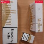 Paczki papierosów leżą na blacie biurka.