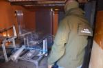 Funkcjonariusz Służby Celno-Skarbowej z maszyną do sortowania papierosów